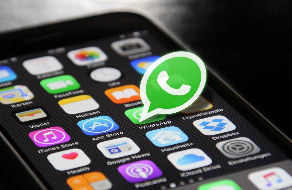 Smartphone screen with WhatsApp icon highlighted, representing WhatsApp marketing services