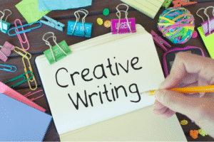 "A notebook open to a page with 'Creative Writing' written on it,