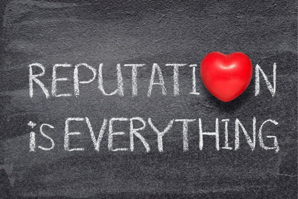 The phrase 'Reputation is Everything' written in chalk on a blackboard, with a shiny red heart replacing the letter 'O' in 'Reputation