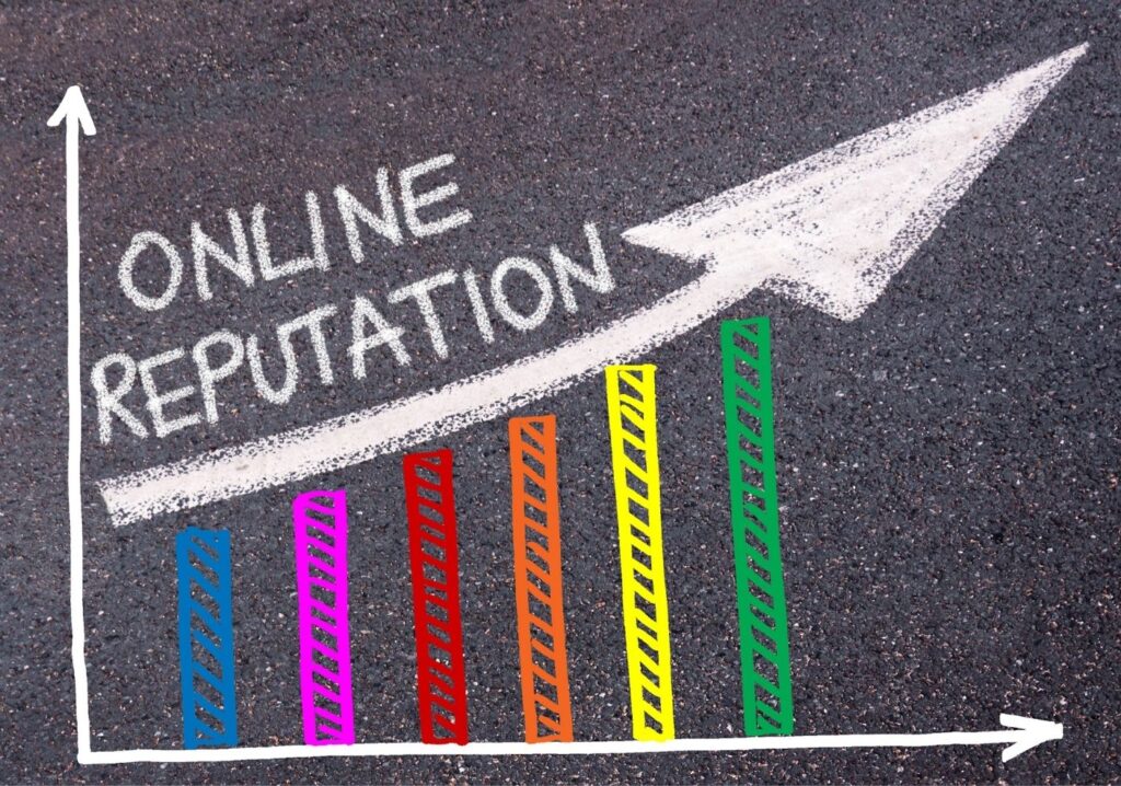 A chalk drawing on pavement shows a rising bar chart and an upward-pointing arrow labeled 'ONLINE REPUTATION' to illustrate growth