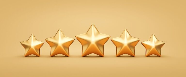 Five gleaming golden stars in a row on a smooth gold background