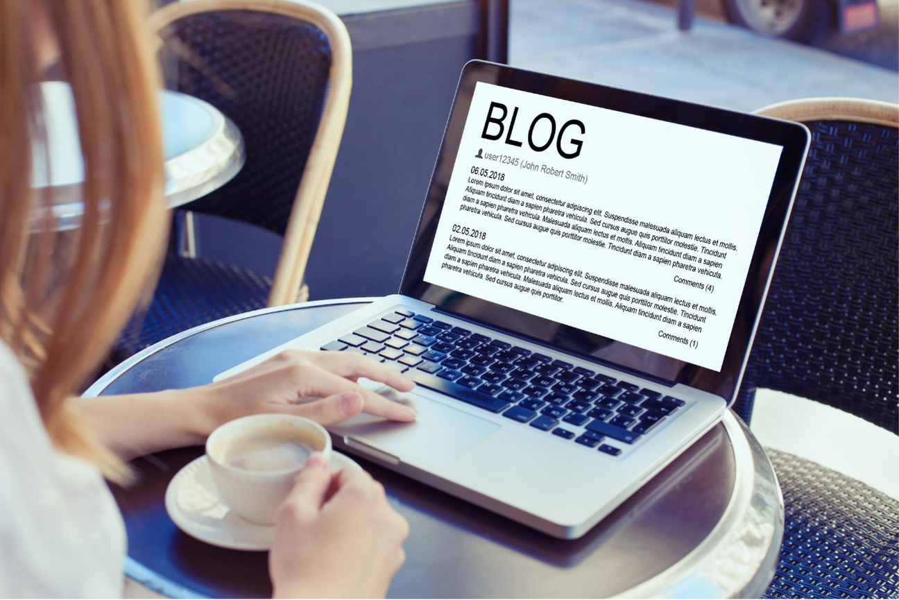 A person viewing a blog post on a laptop screen