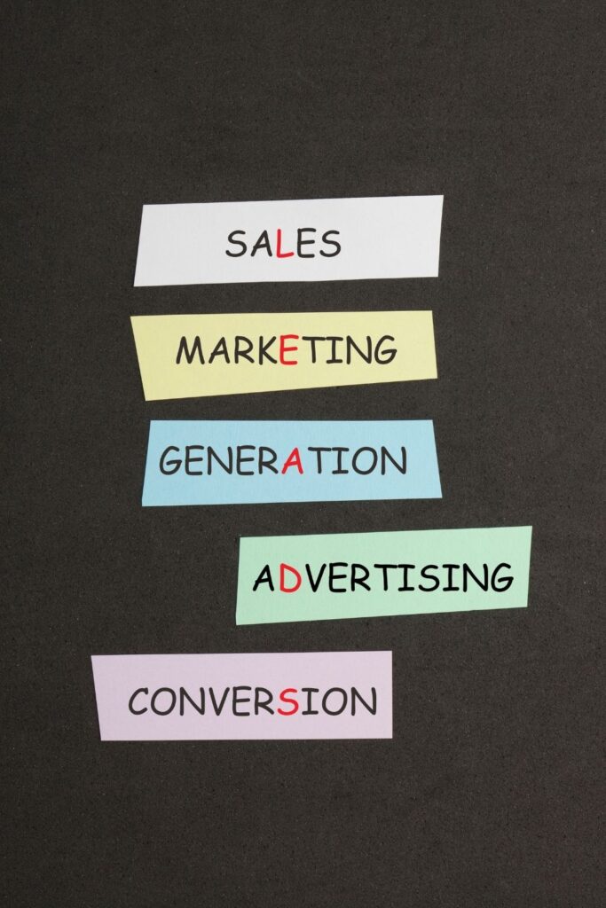 A conceptual image where the words Sales, Marketing, Generation, Advertising, and Conversion are arranged so that highlighted red letters vertically spell out the word 'LEADS'