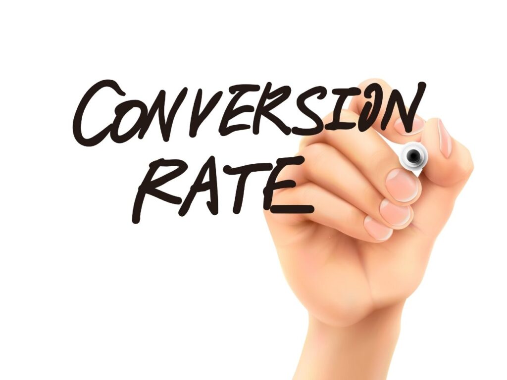 Hand writing the words 'Conversion Rate' in bold marker, symbolizing focus on improving digital marketing performance through CRO