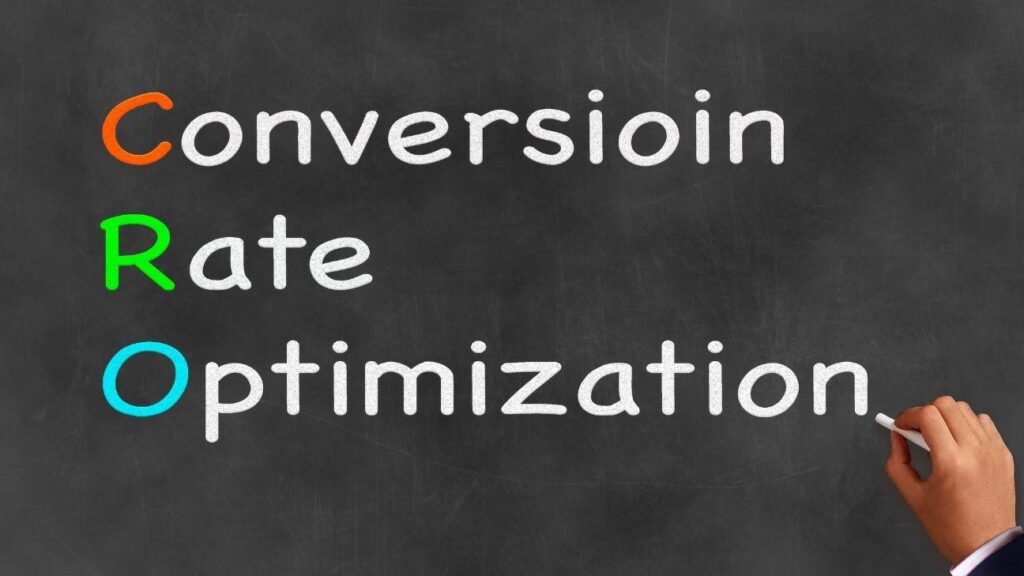 Hand writing the phrase 'Conversion Rate Optimization' on a chalkboard, highlighting the CRO acronym with colorful letters