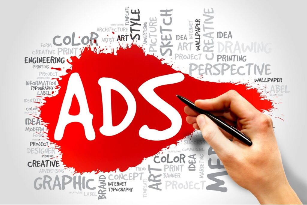 The word 'ADS' on a red paint splatter, with a hand holding a stylus and a background word cloud of design-related terms