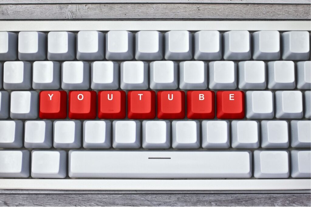 omputer keyboard with red keys spelling “YOUTUBE” – symbolizing digital content creation, online video strategy, and YouTube marketing