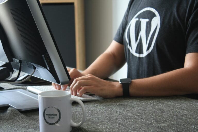A developer wearing a WordPress t-shirt while working on a computer