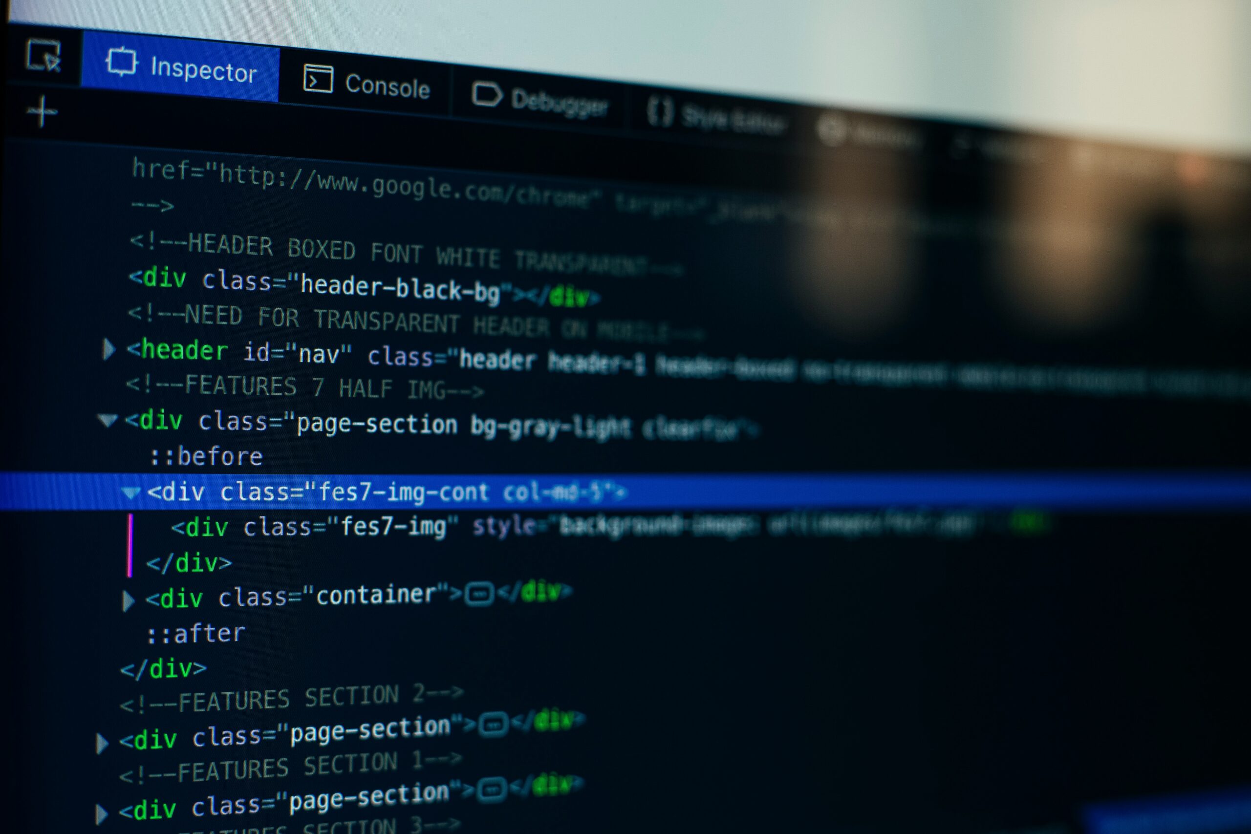 Close-up of computer screen displaying HTML and CSS code for Drupal website development.