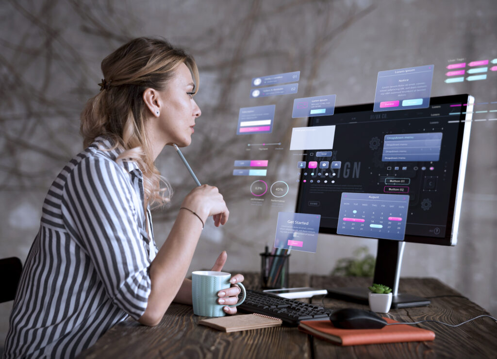 A UI/UX designer thoughtfully planning a website's layout on a computer, with user interface elements shown as floating graphics.